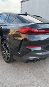 Detailer applying polish to car paint during a professional detail